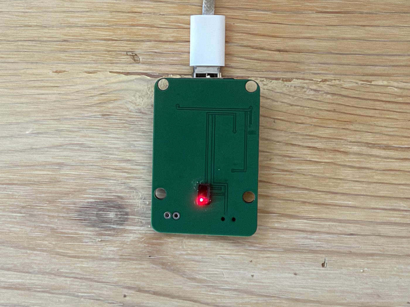Underside of the Tovan-designed board showing the pulse sensor lit red